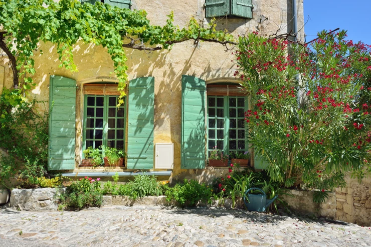 typical cute stone house with colorful shutters in Vaison-la-Romaine France