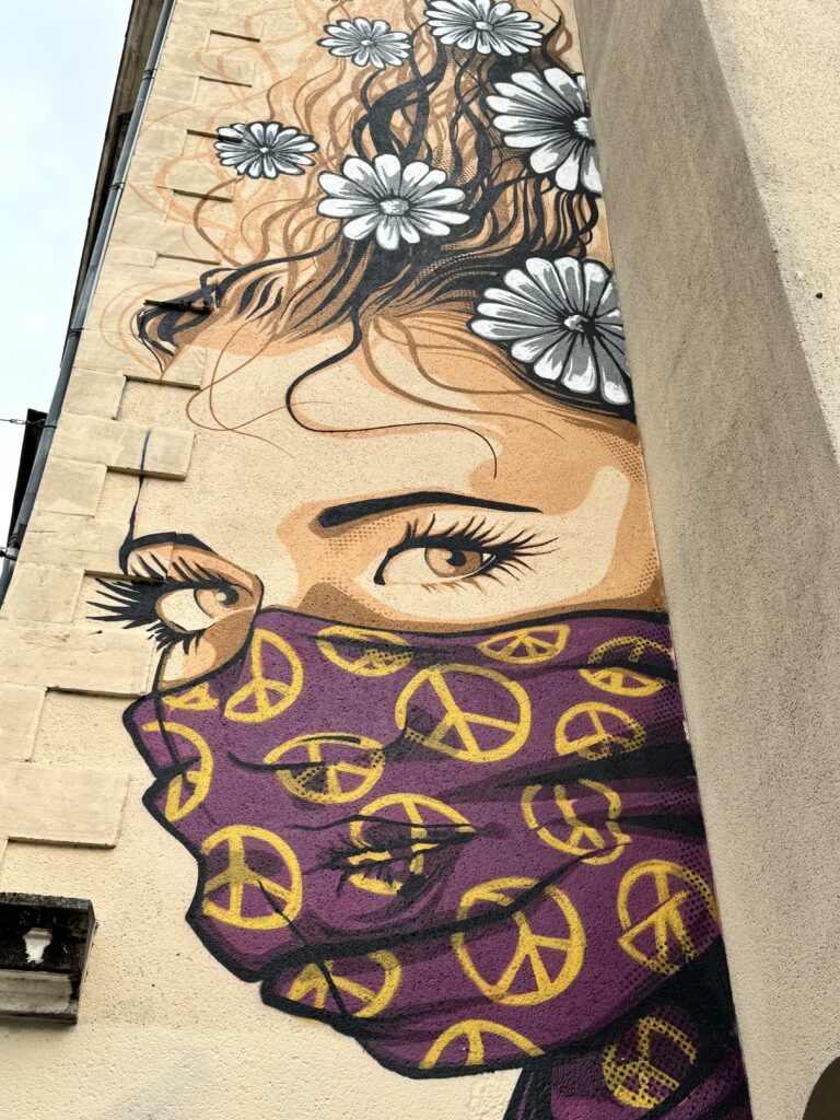 street art mural of woman with flowers in her hair