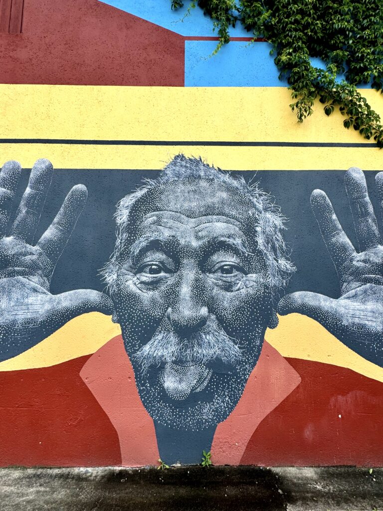 street art mural of a man sticking his tongue out