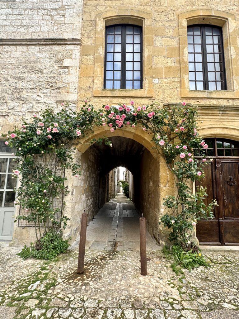 creeping roses over an arch in Monpazier