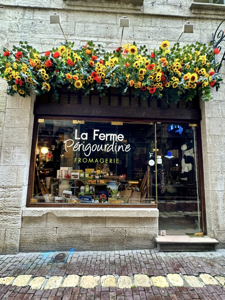 cheese shop with flowers over the door